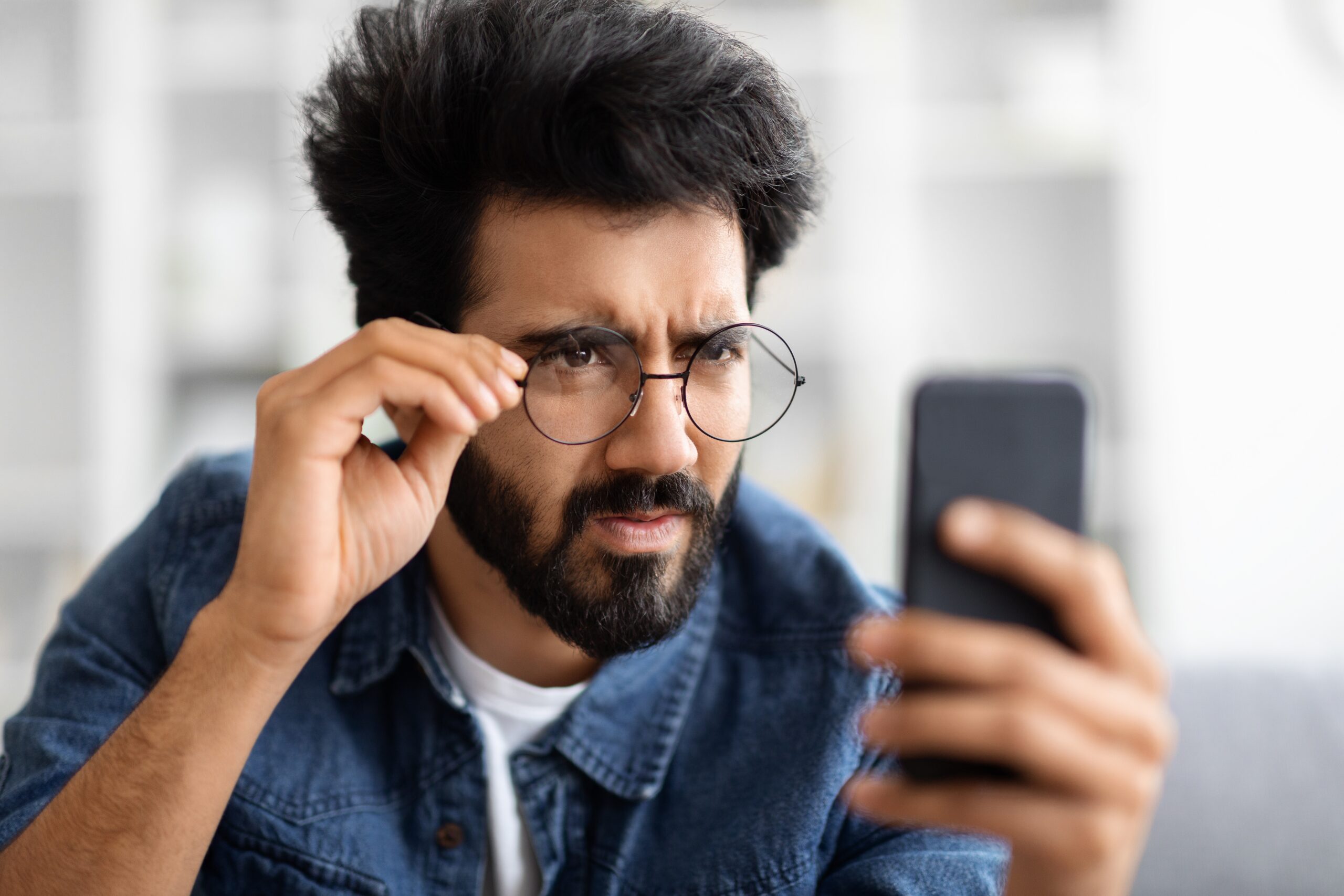 Eyesight problems concept young indian man in eyeglasses looking