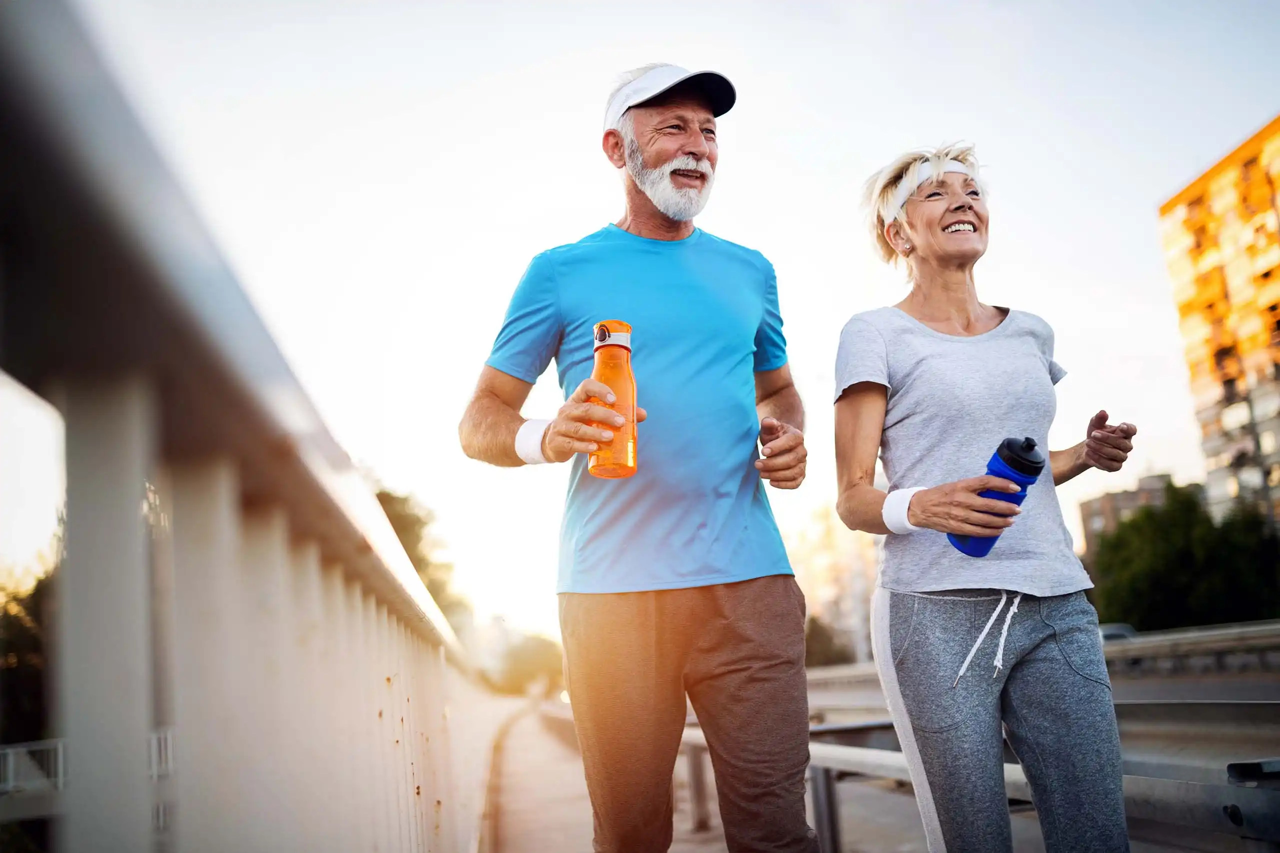 Older couple jogging together outdoors