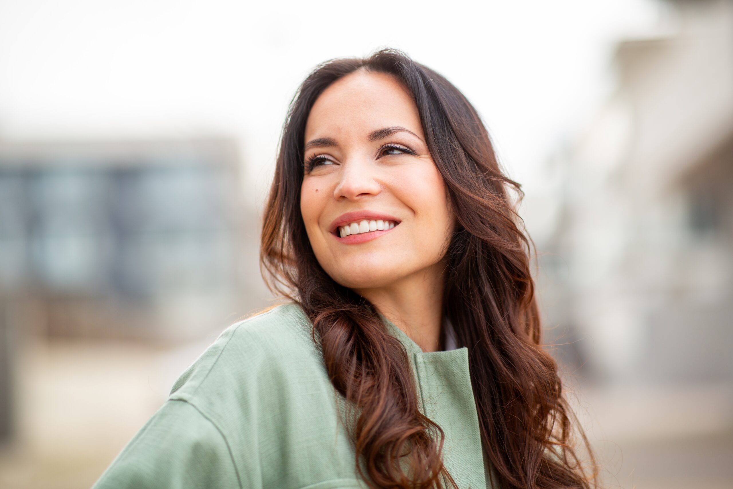 Beautiful young woman smiling and looking away
